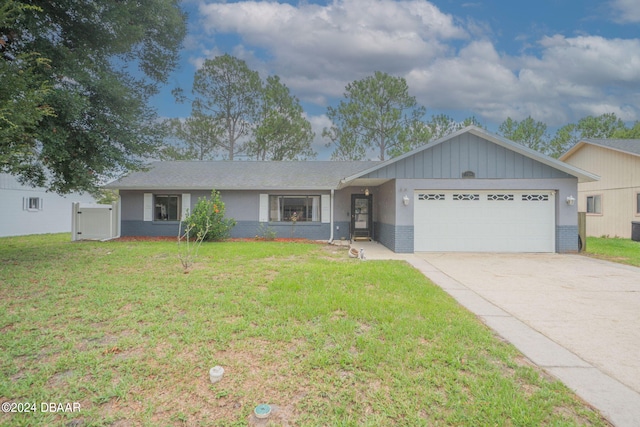 ranch-style house with a garage and a front lawn