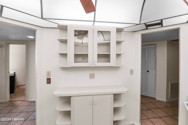 kitchen featuring white cabinets and light tile patterned floors