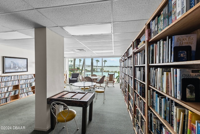 interior space with a paneled ceiling and a water view