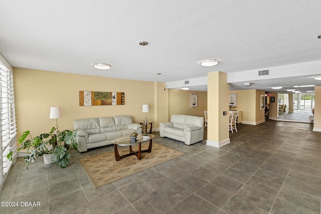 tiled living room with a textured ceiling