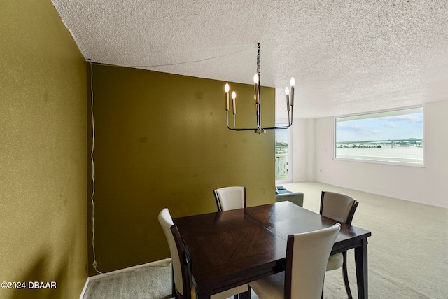 dining area featuring light carpet, a textured ceiling, and an inviting chandelier