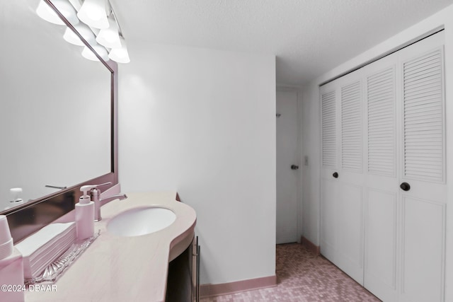 bathroom featuring vanity and a textured ceiling