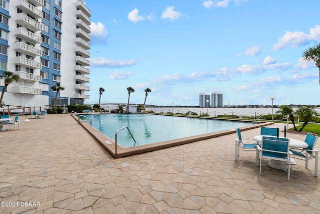 view of swimming pool with a water view