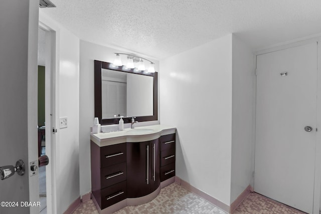 bathroom featuring vanity and a textured ceiling