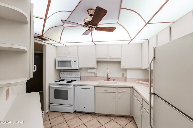 kitchen featuring sink, light tile patterned flooring, ceiling fan, white cabinetry, and white appliances