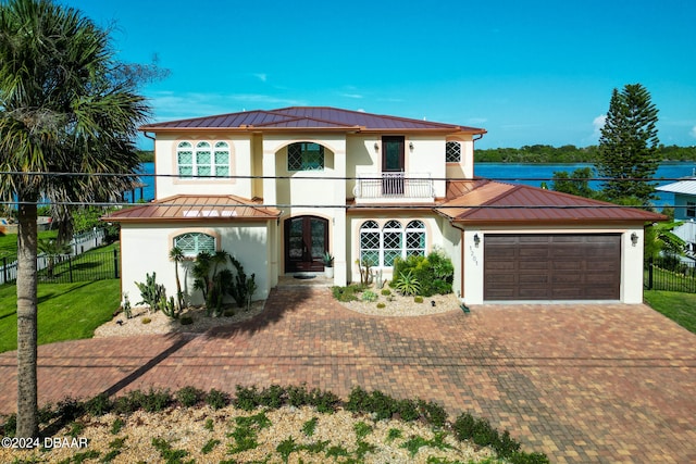 view of front of house featuring a garage and a balcony