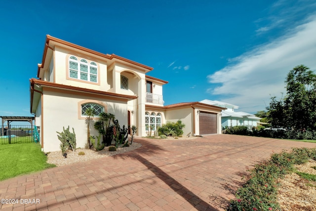 mediterranean / spanish house with a garage