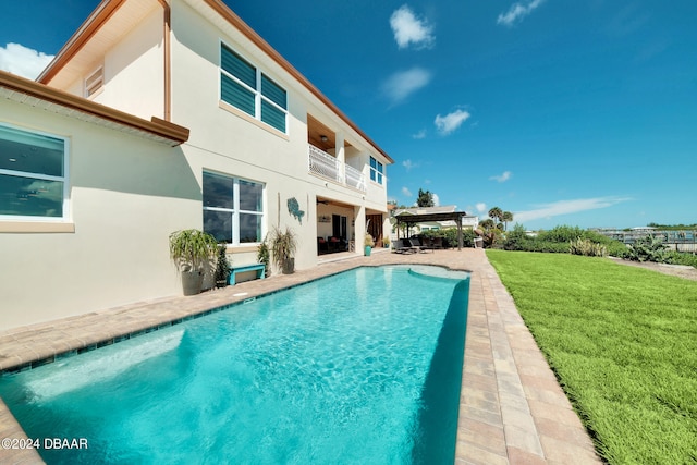 view of pool with a yard and a patio area