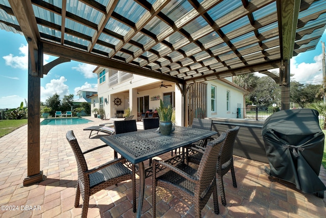 view of patio / terrace with a grill, ceiling fan, and a pergola