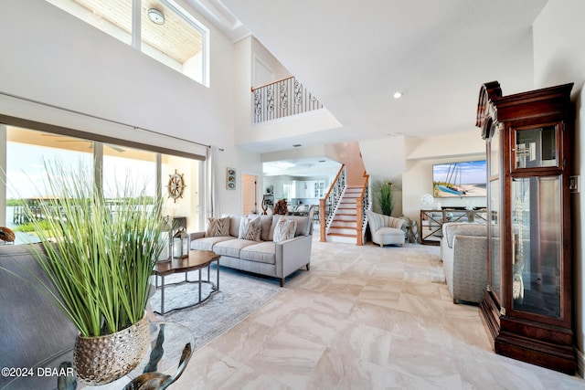 living room featuring a high ceiling and plenty of natural light