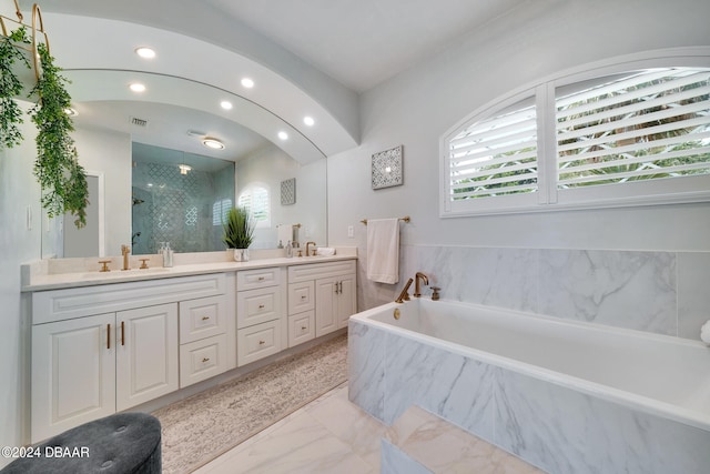 bathroom with shower with separate bathtub and vanity