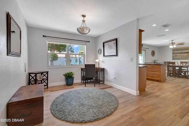 interior space featuring ceiling fan and light wood-type flooring