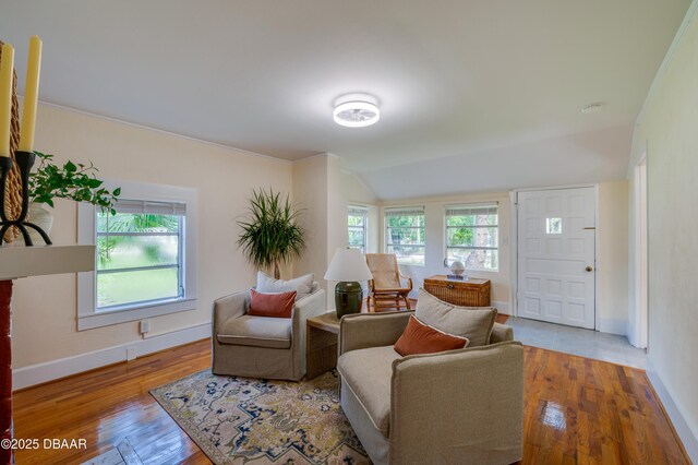 84 Lincoln Ave, Ormond Beach, FL 32174 - unfurnished living room with hardwood / wood-style floors, ornamental molding, baseboards, and a brick fireplace