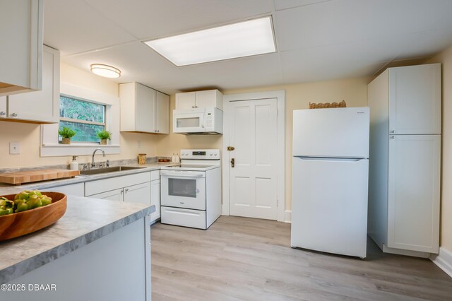 84 Lincoln Ave, Ormond Beach, FL 32174 - kitchen featuring white appliances, a sink, white cabinetry, and light countertops