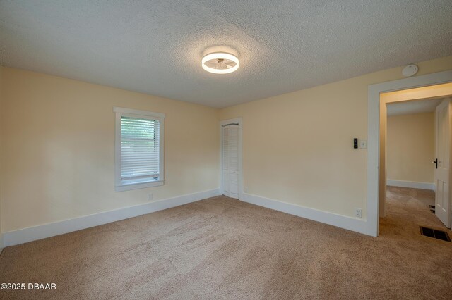 84 Lincoln Ave, Ormond Beach, FL 32174 - carpeted empty room featuring baseboards, a textured ceiling, and a smoke detector