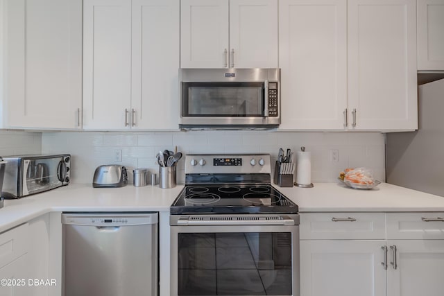 kitchen featuring appliances with stainless steel finishes and white cabinetry