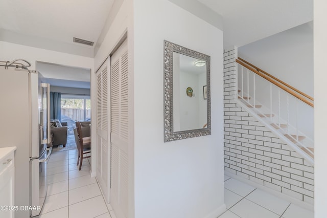 hallway featuring light tile patterned floors