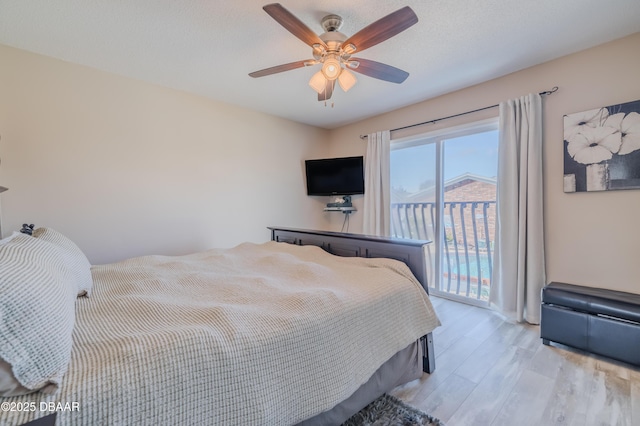 bedroom featuring light wood-type flooring, ceiling fan, and access to exterior