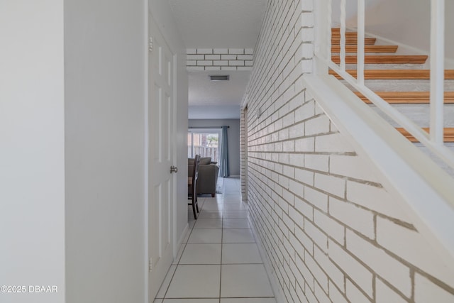 hall featuring light tile patterned floors