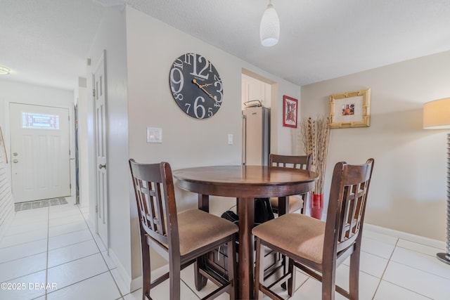 dining area featuring light tile patterned floors