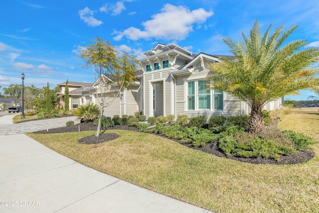 view of front of home with a garage and a front lawn