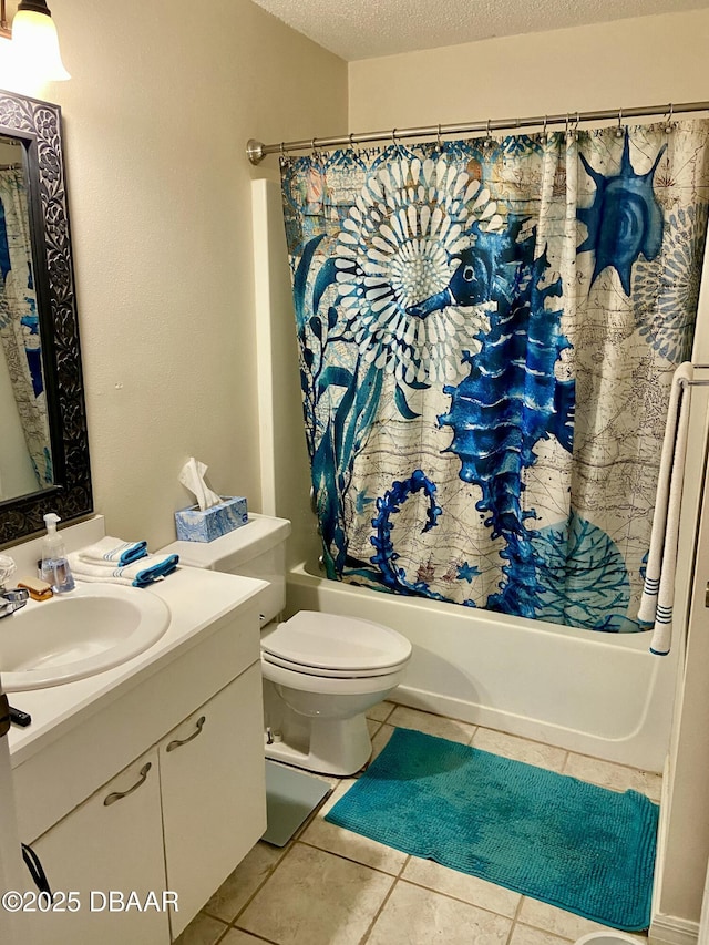 full bath with toilet, shower / bath combo with shower curtain, a textured ceiling, vanity, and tile patterned floors