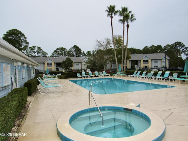 community pool with a community hot tub, a patio area, and fence