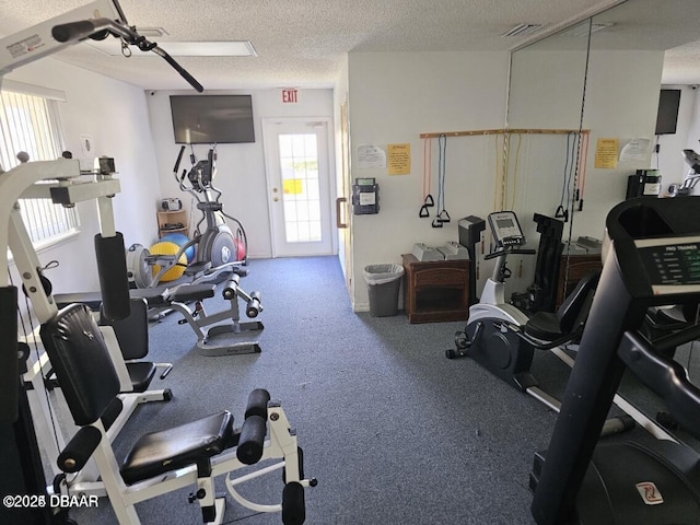 workout area with visible vents and a textured ceiling