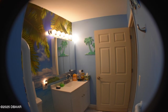bathroom featuring toilet and vanity