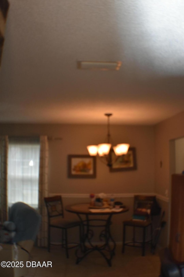 dining space with an inviting chandelier