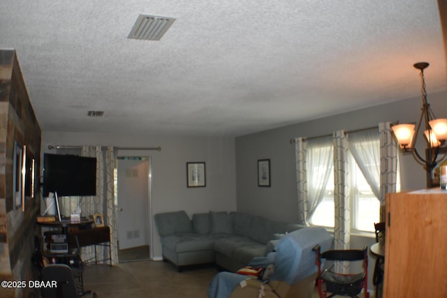 living room featuring a textured ceiling and visible vents