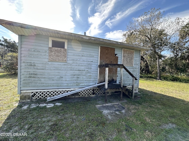 view of outbuilding with a lawn