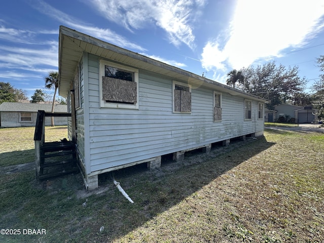 view of side of home with a lawn