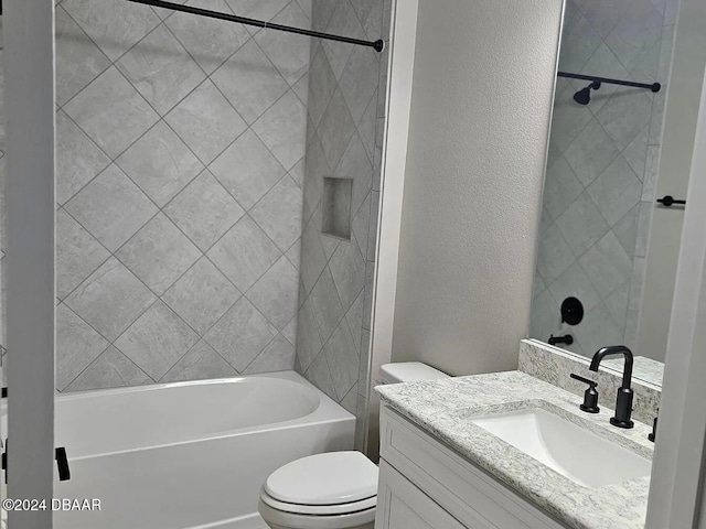 full bathroom with toilet, vanity, and tiled shower / bath combo