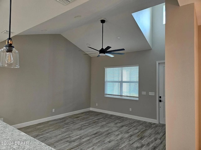 empty room with ceiling fan, hardwood / wood-style flooring, and high vaulted ceiling