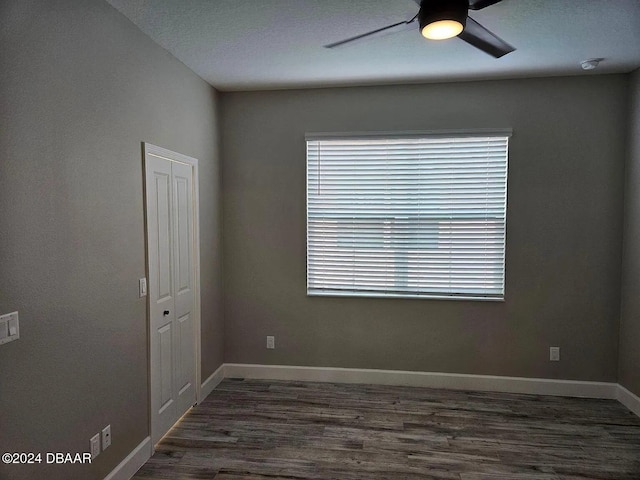 unfurnished room with ceiling fan and dark hardwood / wood-style floors