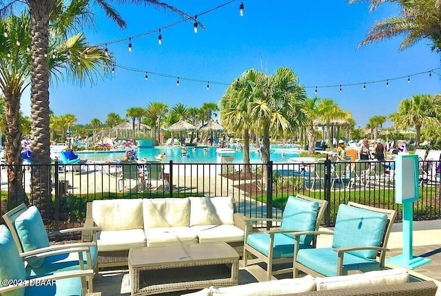 view of patio with an outdoor living space and a community pool