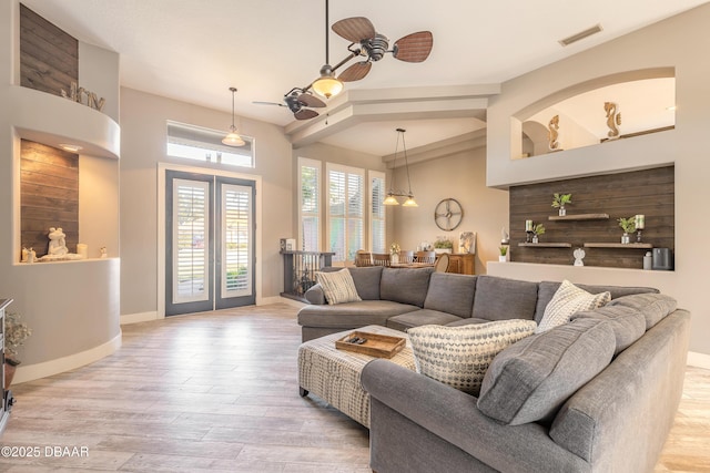 living room featuring ceiling fan, french doors, and light wood-type flooring