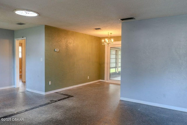 empty room with visible vents, a textured ceiling, baseboards, and speckled floor