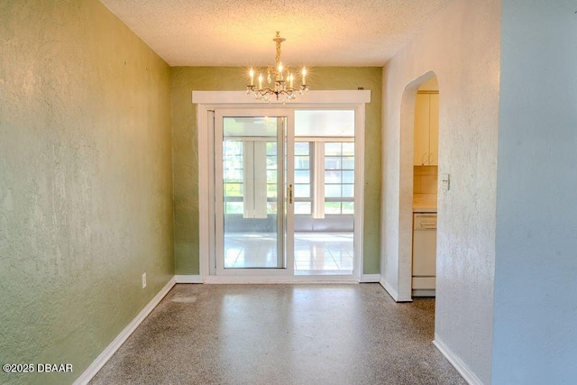 entryway featuring speckled floor, a textured ceiling, and a textured wall