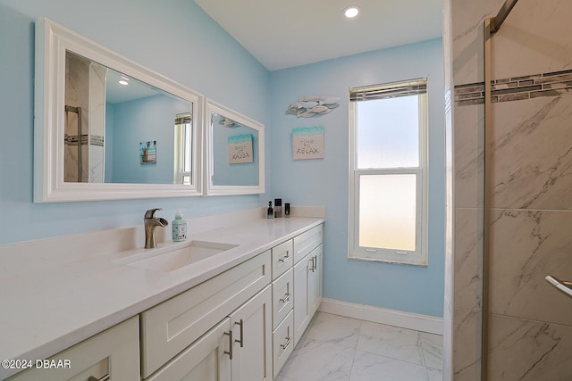 bathroom with vanity, a tile shower, and plenty of natural light