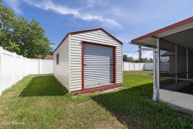 view of outbuilding featuring a sunroom and a yard