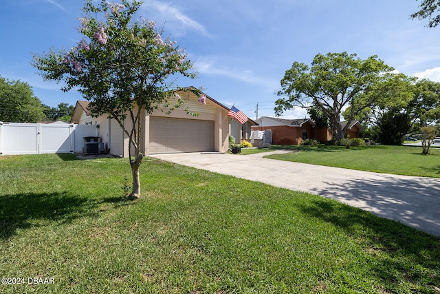 view of front facade featuring central AC unit, a garage, and a front lawn