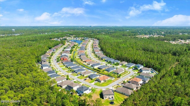 aerial view featuring a wooded view and a residential view