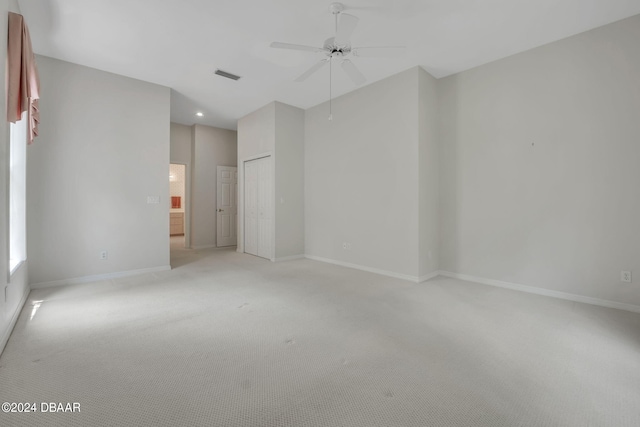 spare room with light colored carpet and ceiling fan