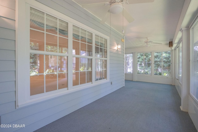 unfurnished sunroom with ceiling fan