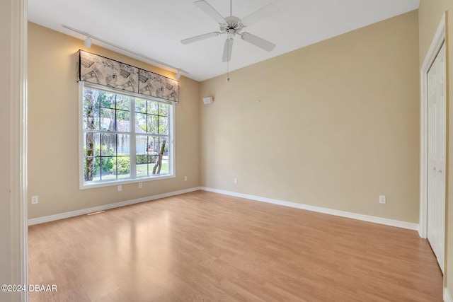 empty room with light hardwood / wood-style flooring and ceiling fan