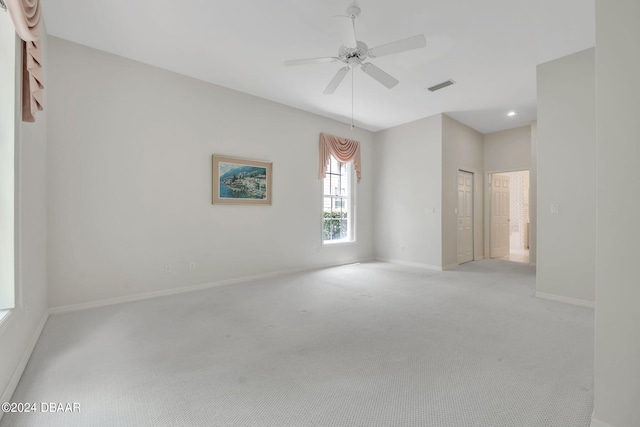 spare room featuring ceiling fan and light colored carpet