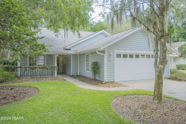 single story home featuring a garage and a front yard