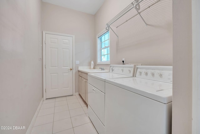 washroom with cabinets, washer and clothes dryer, sink, and light tile patterned floors